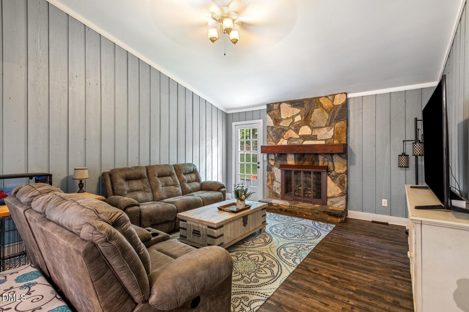 134 Longview Road Madison, NC 27025 - Photo 7 of 49 a living room with furniture a flat screen tv and a fireplace