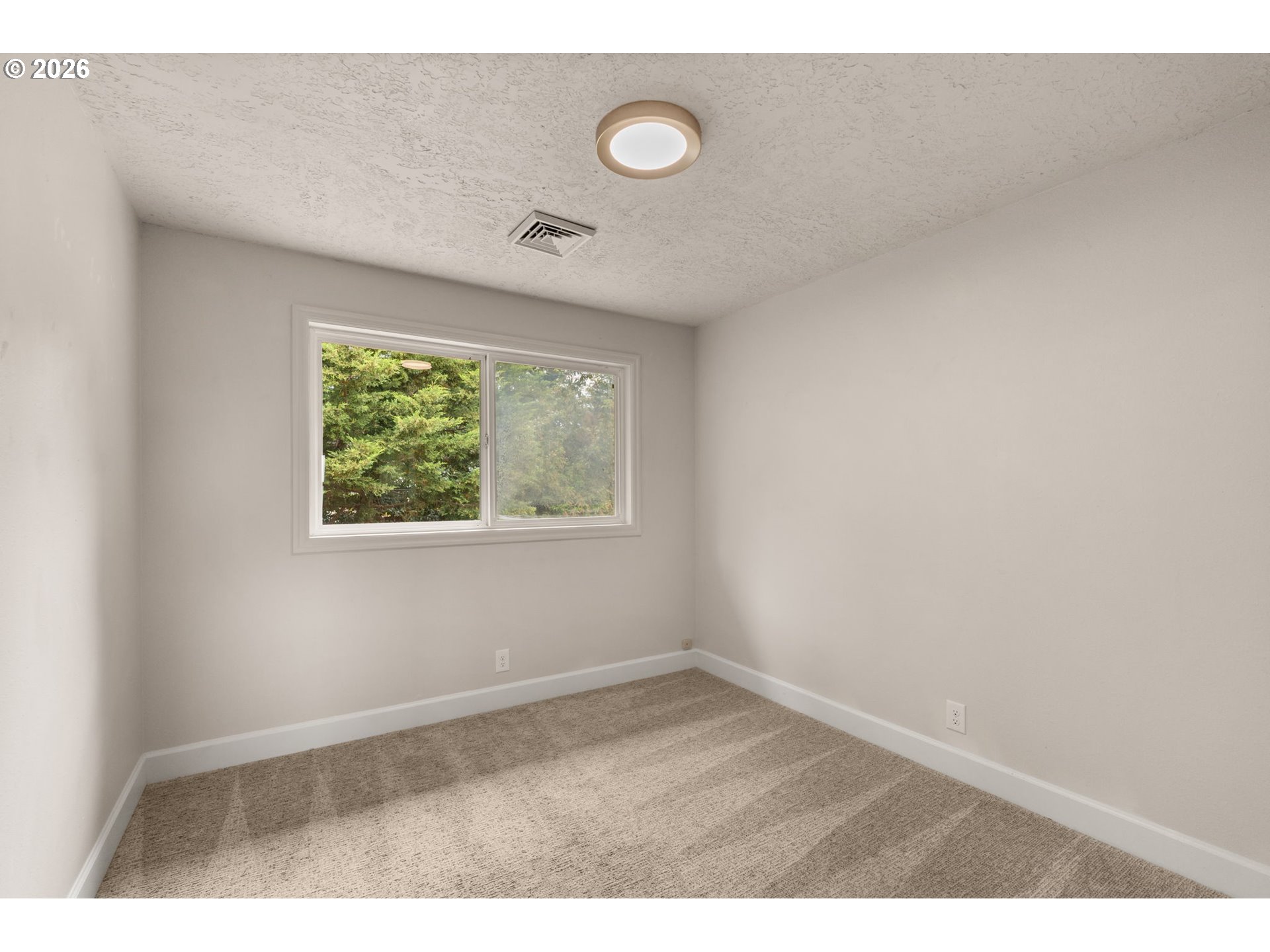 1995 Greiner Street Eugene, OR 97405 - Photo 29 of 39 an empty room with wooden floor and windows