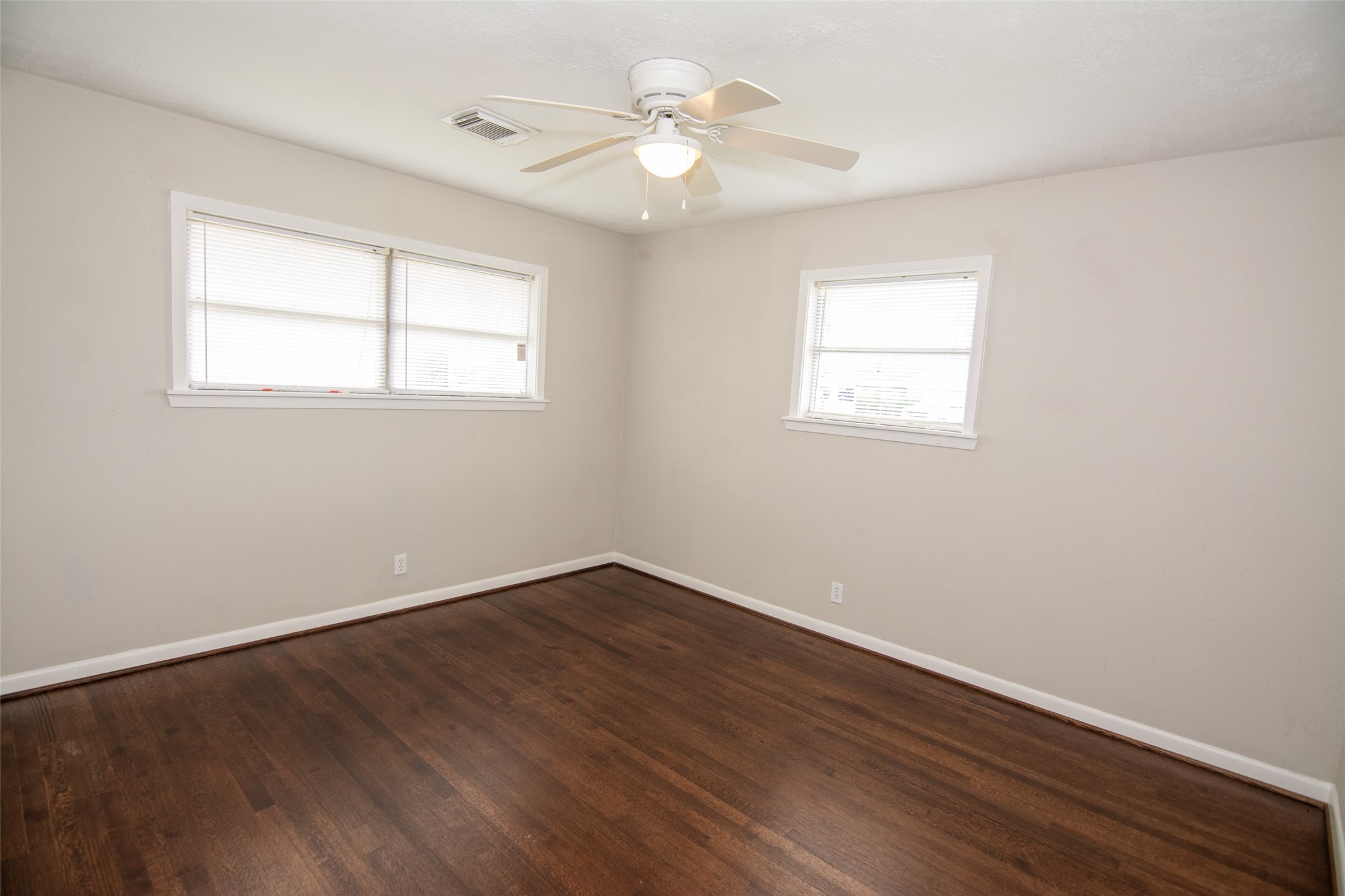 103 East Janisch Road Houston, TX 77022 - Photo 11 of 18 wooden floor in an empty room with a window