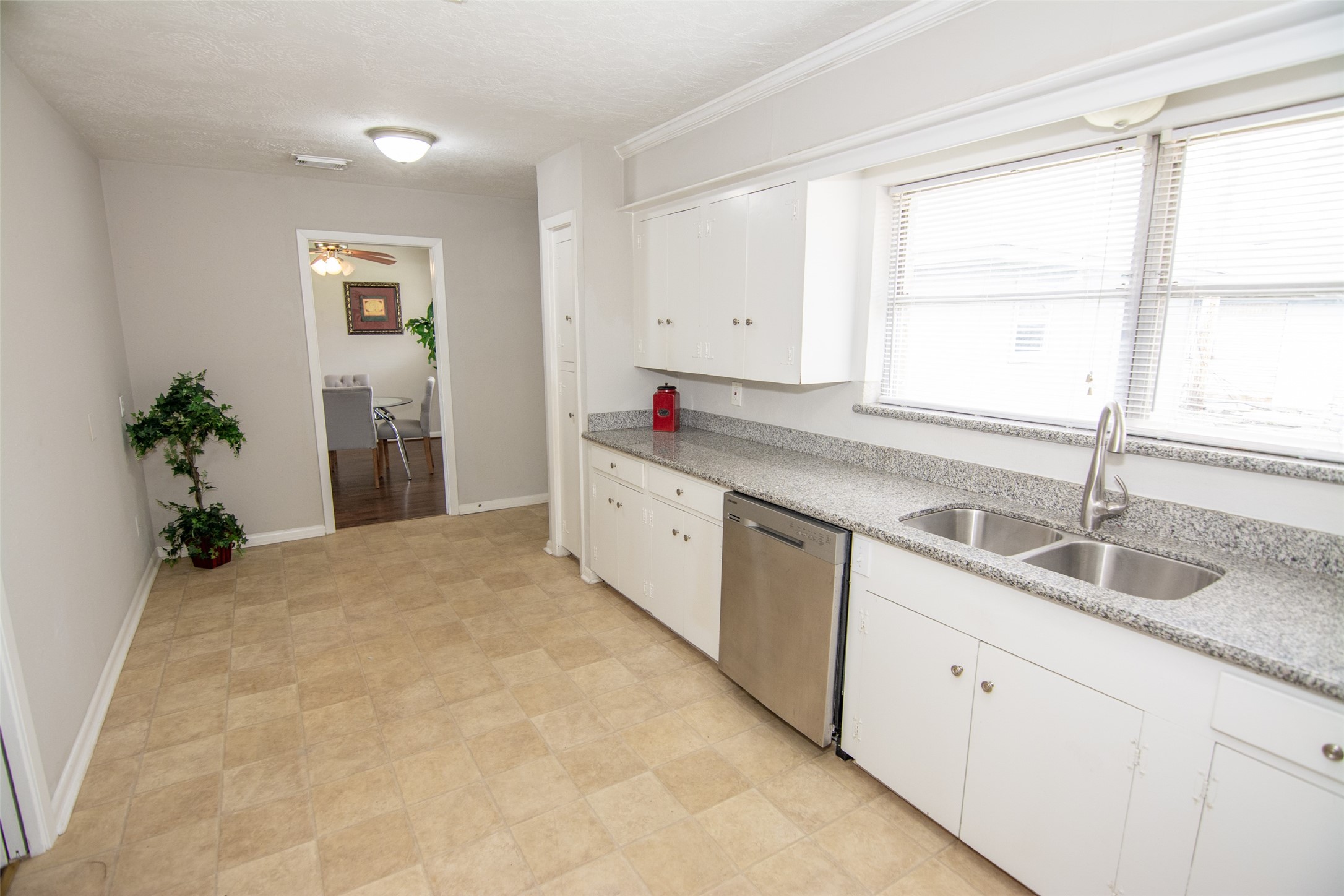 103 East Janisch Road Houston, TX 77022 - Photo 3 of 18 a kitchen with granite countertop a sink and a window