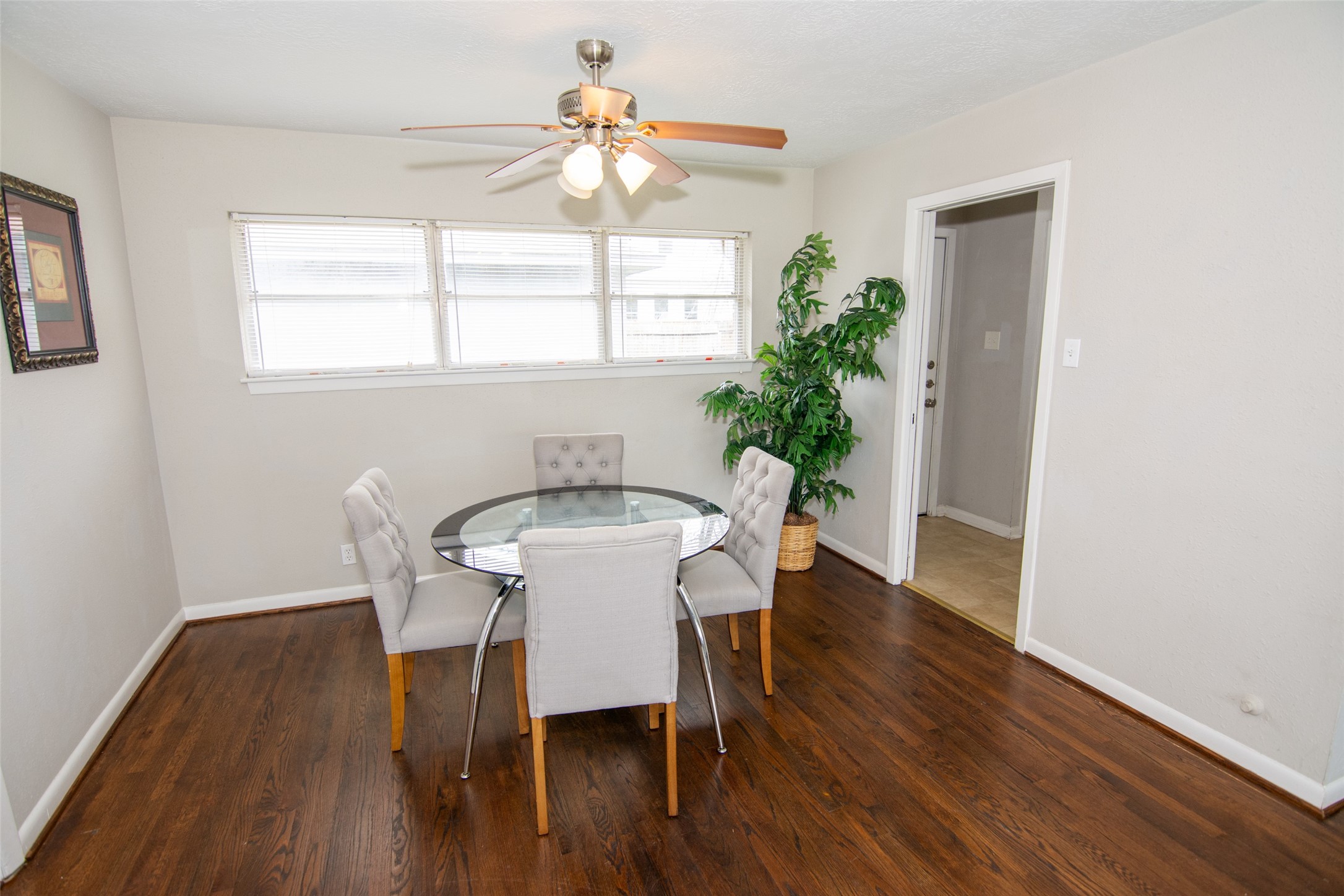 103 East Janisch Road Houston, TX 77022 - Photo 7 of 18 a view of a dining room with furniture window and wooden floor