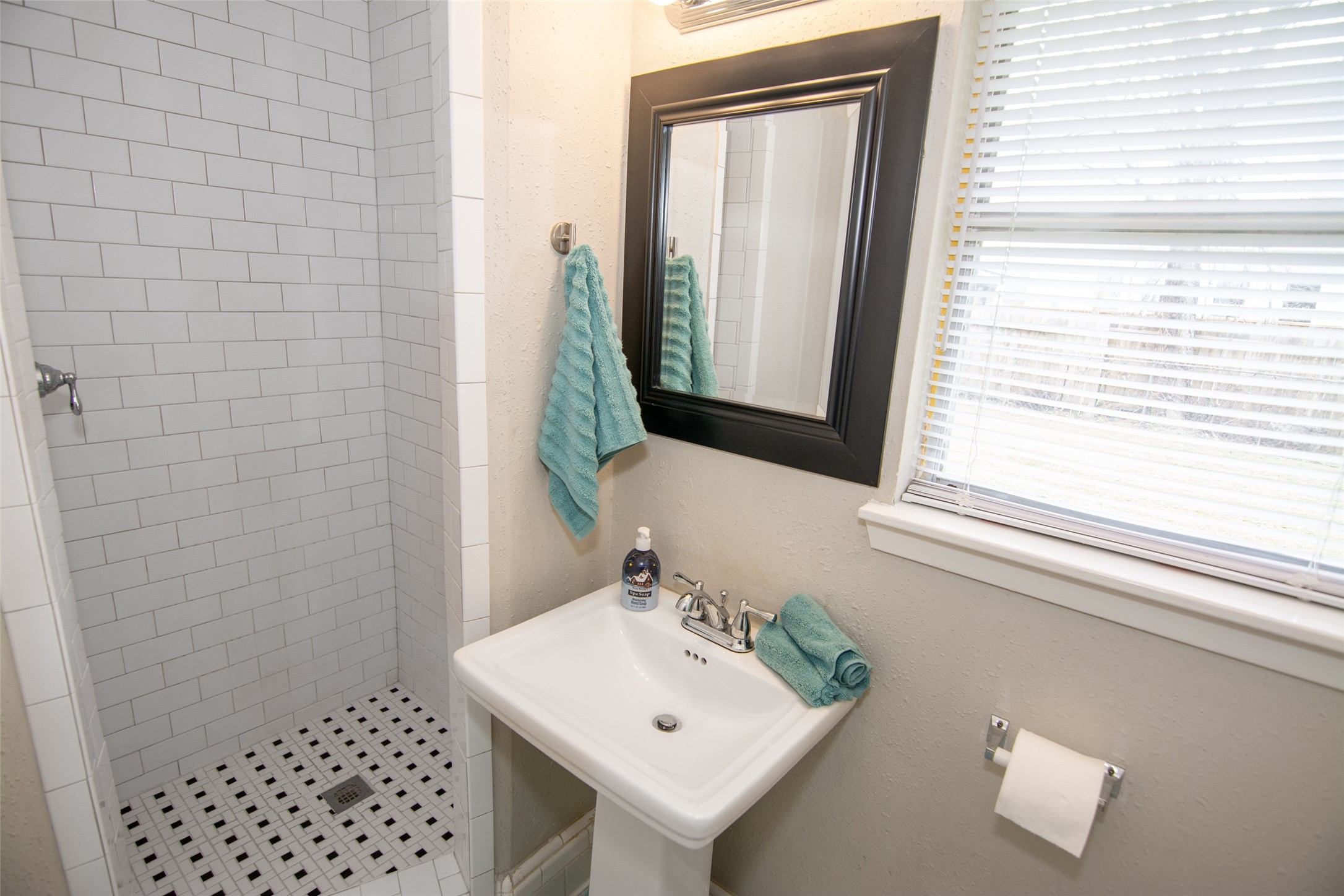 103 East Janisch Road Houston, TX 77022 - Photo 10 of 18 a bathroom with a sink a mirror and a window
