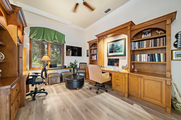 a spacious bedroom with a bed and glass walk in closet