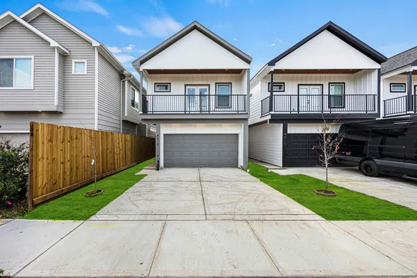 a front view of a house with a yard and a garage