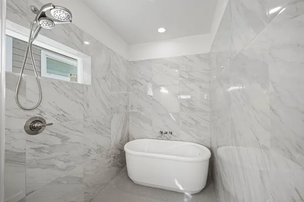 a bathroom with a bathtub and shower