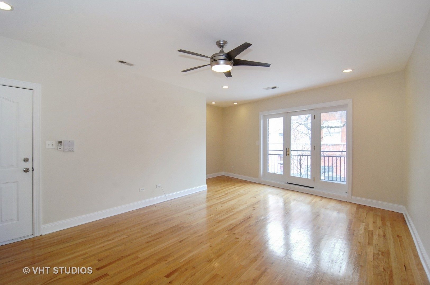 31 East 26th Street, Unit 3 Chicago, IL 60616 - Photo 2 of 10 an empty room with wooden floor fan and windows