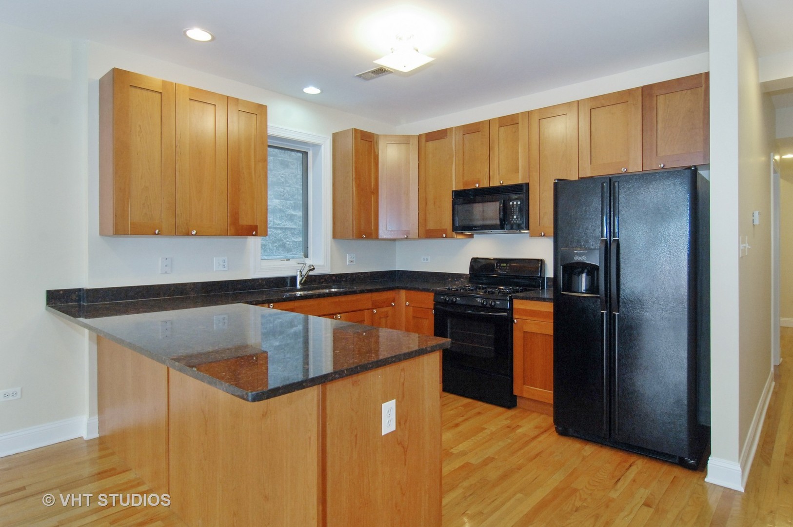 31 East 26th Street, Unit 3 Chicago, IL 60616 - Photo 3 of 10 a kitchen with stainless steel appliances granite countertop a refrigerator a stove and a sink