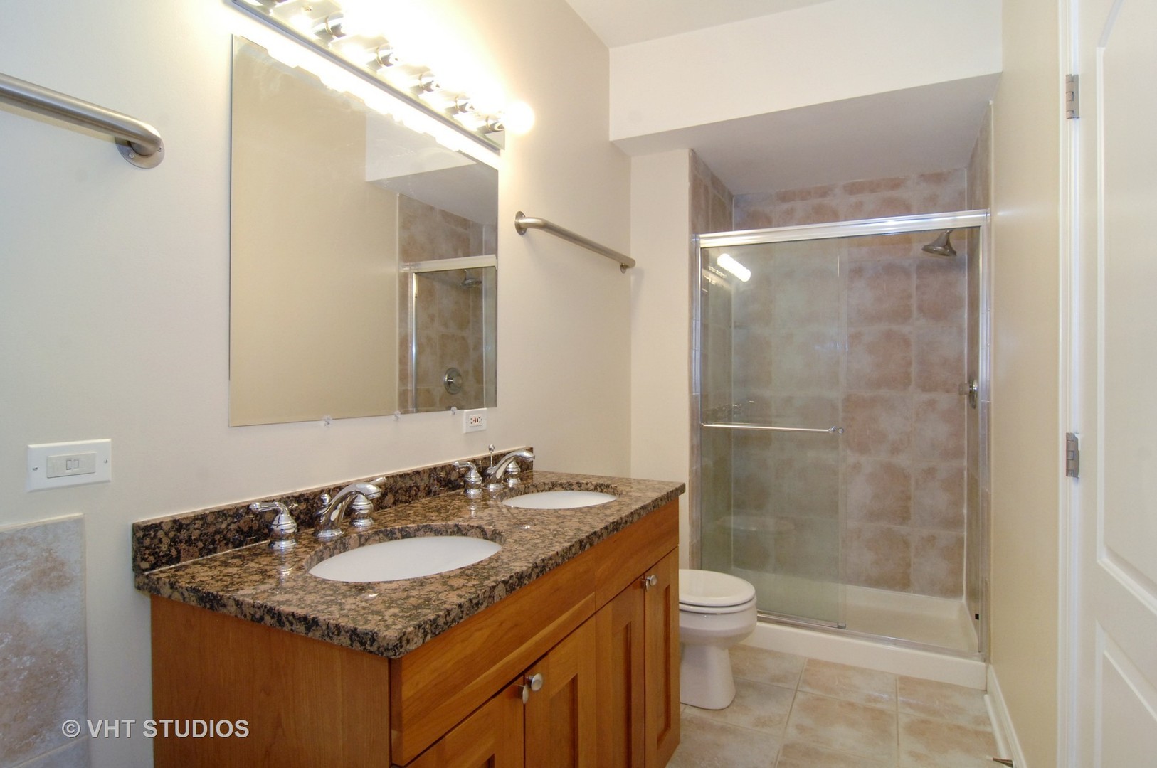 31 East 26th Street, Unit 3 Chicago, IL 60616 - Photo 5 of 10 a bathroom with a granite countertop sink toilet and shower