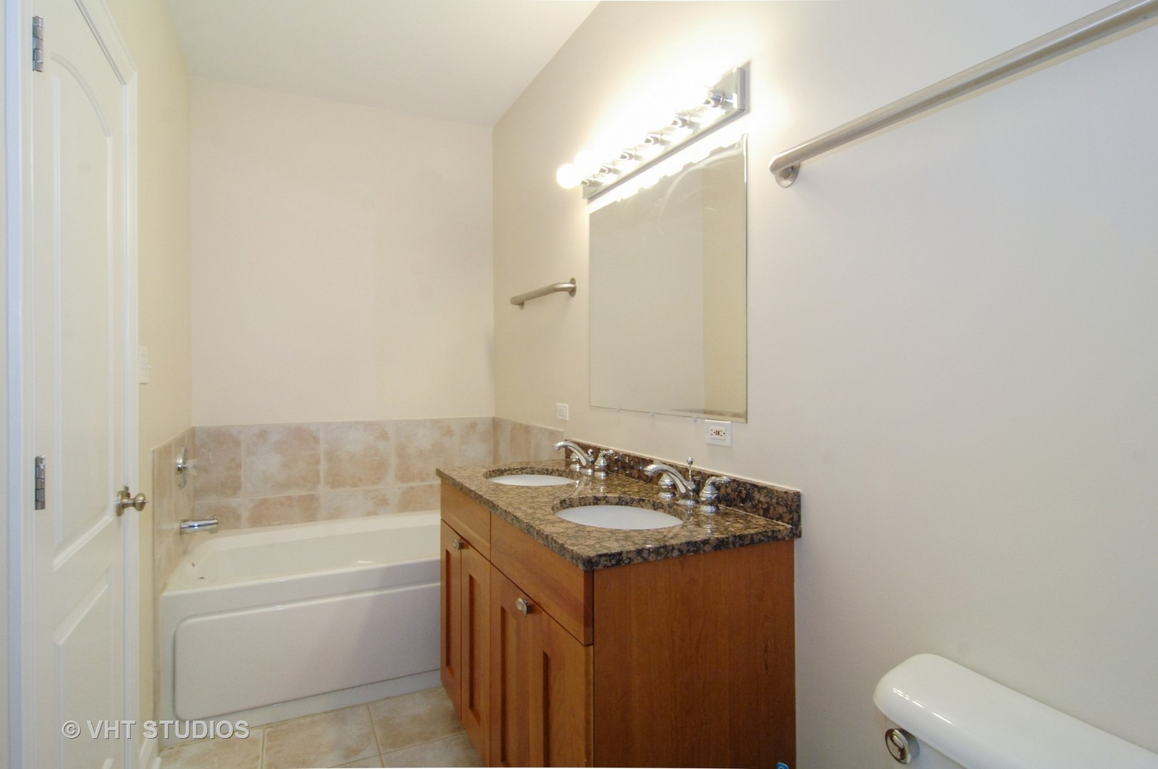 31 East 26th Street, Unit 3 Chicago, IL 60616 - Photo 6 of 10 a bathroom with a granite countertop sink a toilet a mirror and bathtub