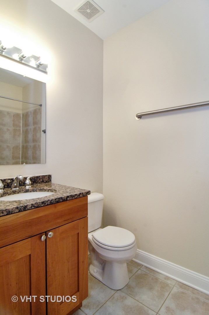 31 East 26th Street, Unit 3 Chicago, IL 60616 - Photo 8 of 10 a bathroom with a granite countertop toilet and a sink