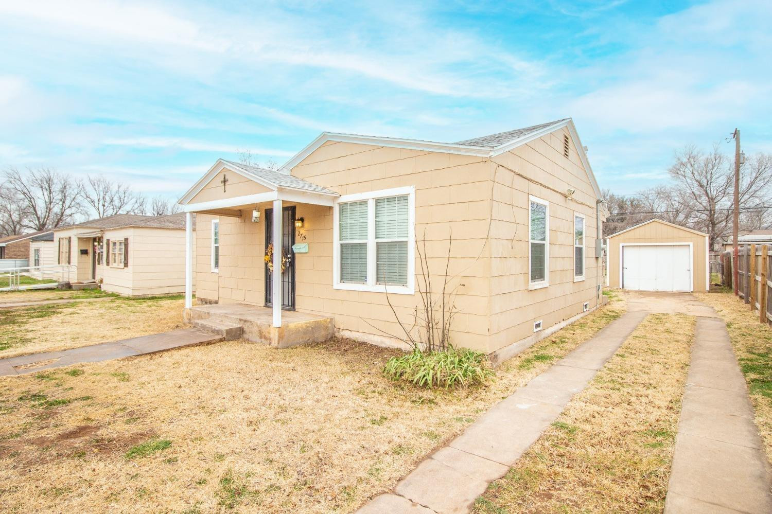 2715 36th Street Lubbock, TX 79413 - Photo 10 of 14 a front view of a house with a yard