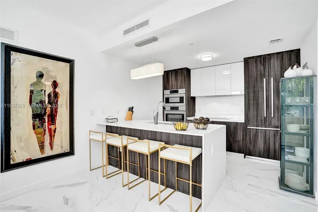 a kitchen with stainless steel appliances a sink and a refrigerator