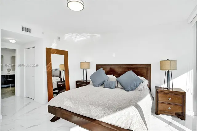 a bedroom with a bed and a table