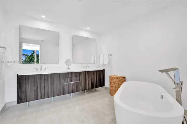 a bathroom with a bathtub sink and mirror