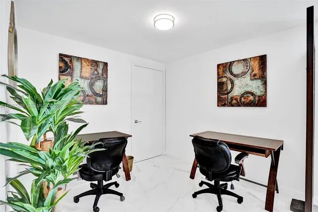 a view of a workspace with furniture and a potted plant