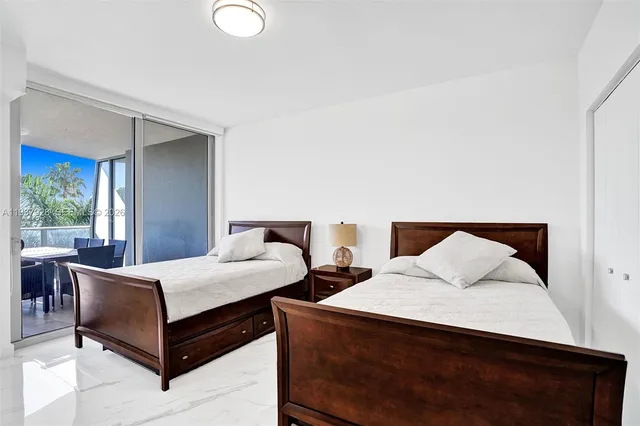 a bedroom with two beds and a large window