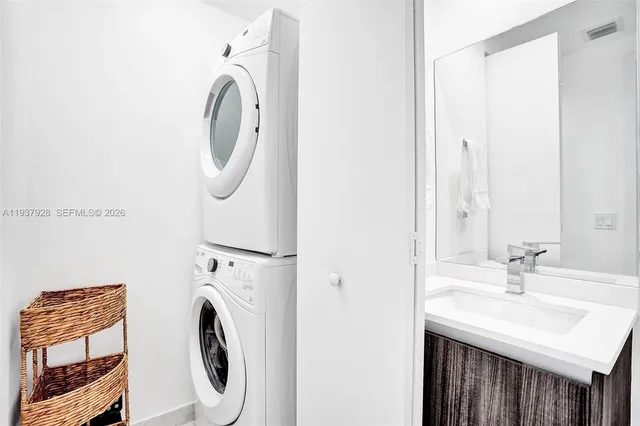 a bathroom with a sink a washer and dryer