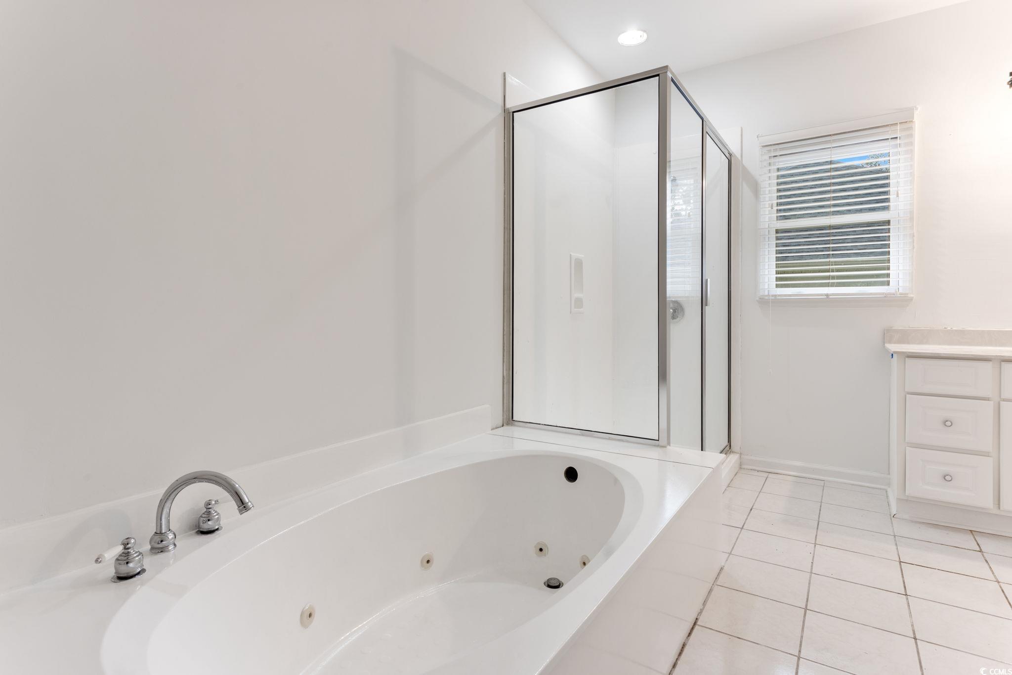 2321 Brick Drive Longs, SC 29568 - Photo 25 of 40 Bathroom featuring light tile patterned floors, a stall shower, vanity, and a whirlpool tub
