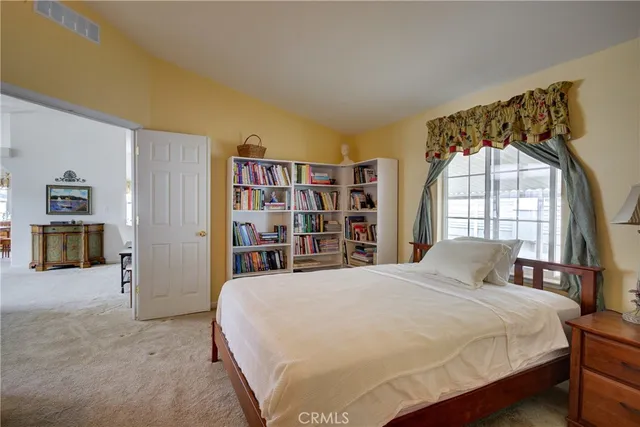 a spacious bedroom with a bed and a large window