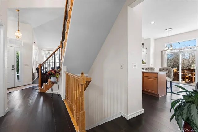 a view of hallway with wooden floor and stairs