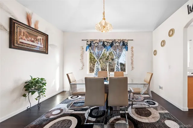 a dining room with furniture and wooden floor