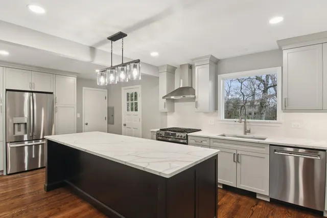 a kitchen with a sink stove and refrigerator