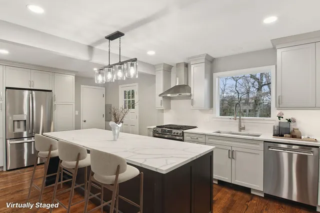 a kitchen with a sink a stove a dining table and chairs