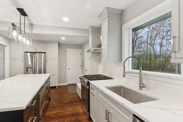 a kitchen with a sink and a stove top oven