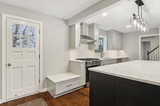 a kitchen with stainless steel appliances a stove a sink and a refrigerator