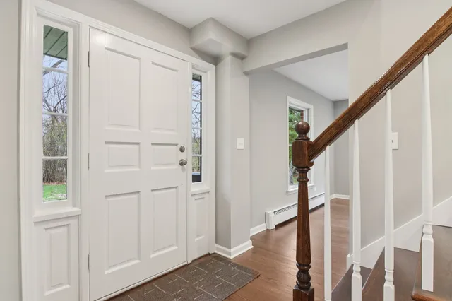 a view of entryway with wooden floor and stairs