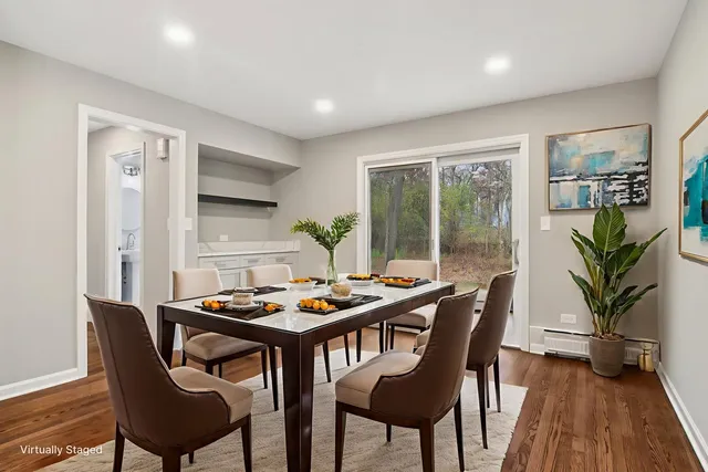 a dining room with furniture window and wooden floor