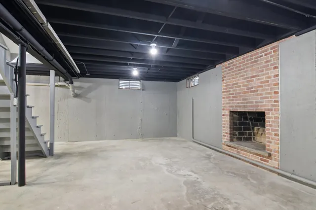 a view of an empty room with a fireplace