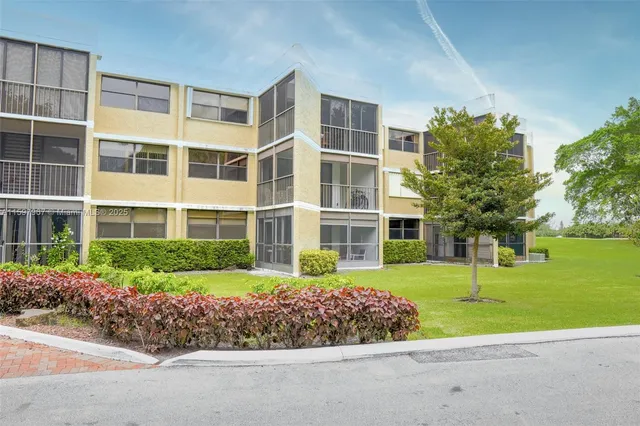 front view of a building with a garden