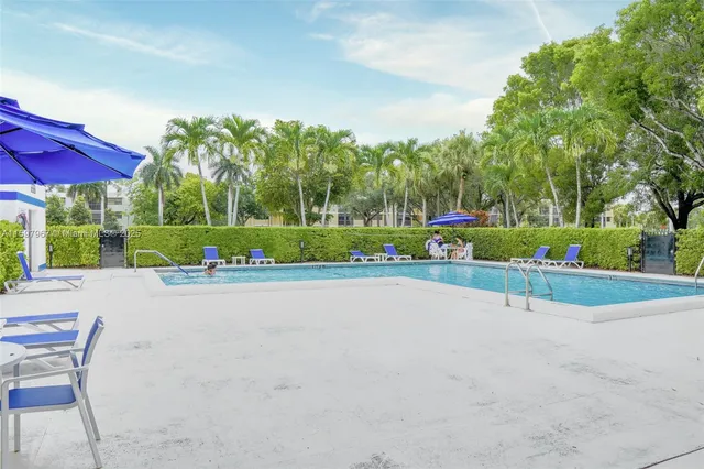 front view of a house with a yard and potted plants