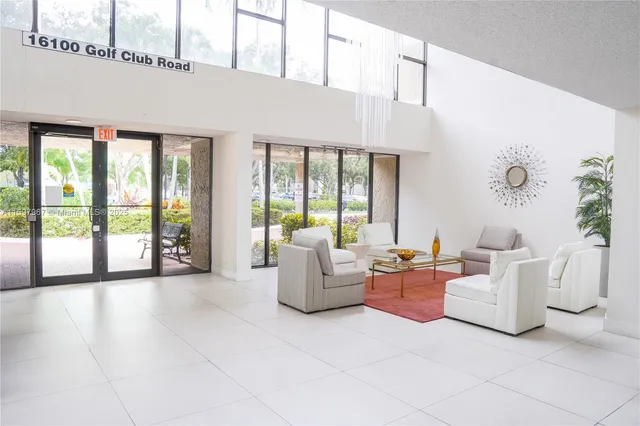 a living room with fireplace furniture and a large window