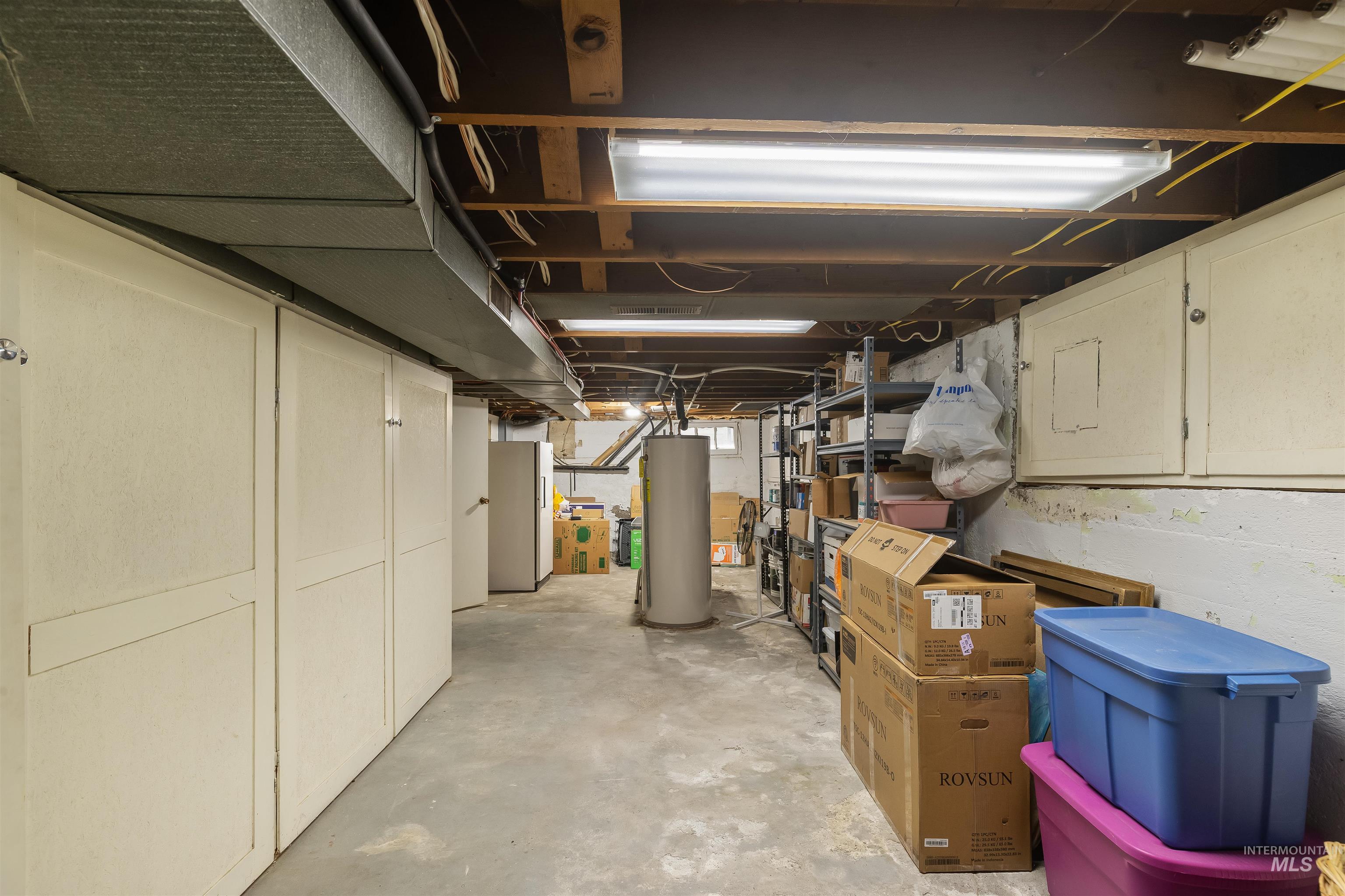 924 N Street Lewiston, ID 83501 - Photo 30 of 46 Utility space featuring exposed ceiling joists, fluorescent lighting, and a concrete floor