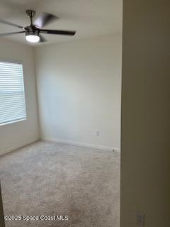 1110 Trinity Street Rockledge, FL 32955 - Photo 17 of 23 an empty room with a chandelier fan and windows