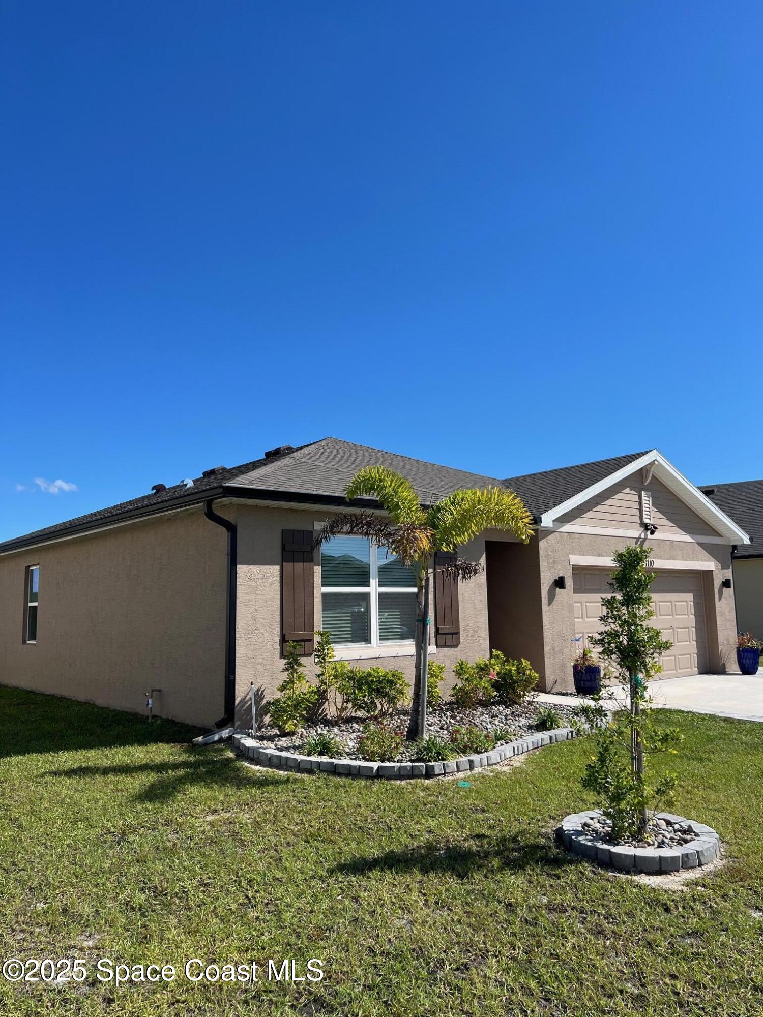 1110 Trinity Street Rockledge, FL 32955 - Photo 3 of 23 a front view of a house with garden