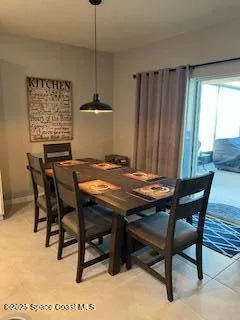 a view of a dining table and chairs in a room