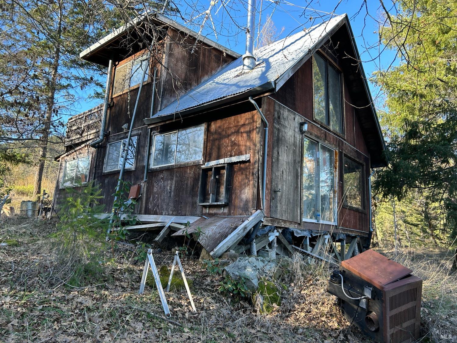 9000 Spyrock Road Covelo, CA 95428 - Photo 4 of 33 a backyard of a house with table and chairs