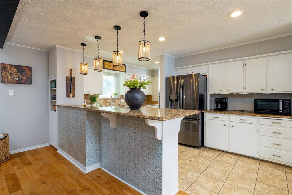 205 Timberlake Drive Azle, TX 76020 - Photo 6 of 40 a kitchen with stainless steel appliances a refrigerator sink and microwave