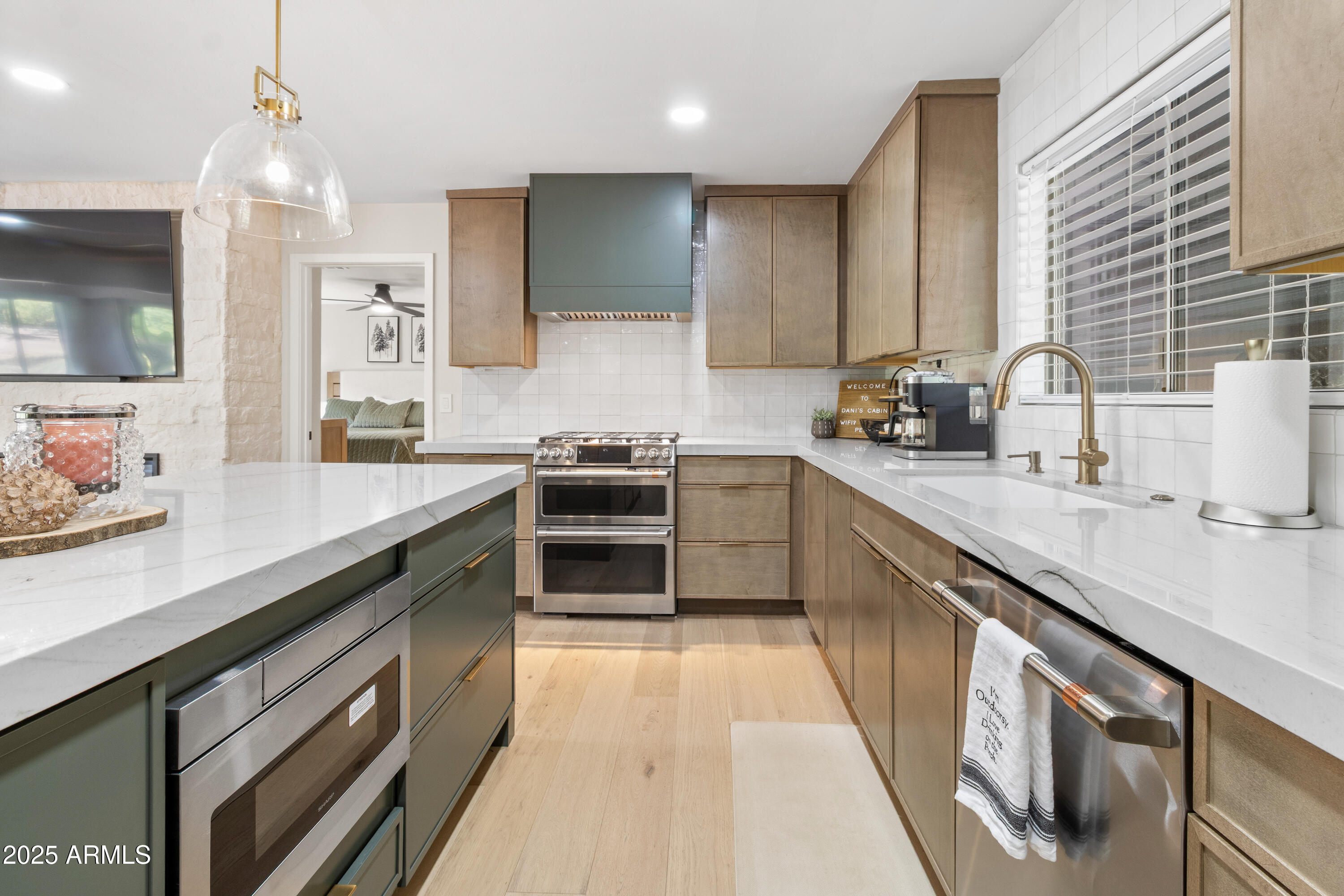 7451 Buck Springs Road Pinetop, AZ 85935 - Photo 11 of 35 a kitchen with stainless steel appliances a sink stove and cabinets