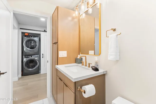 a utility room with sink dryer and washer