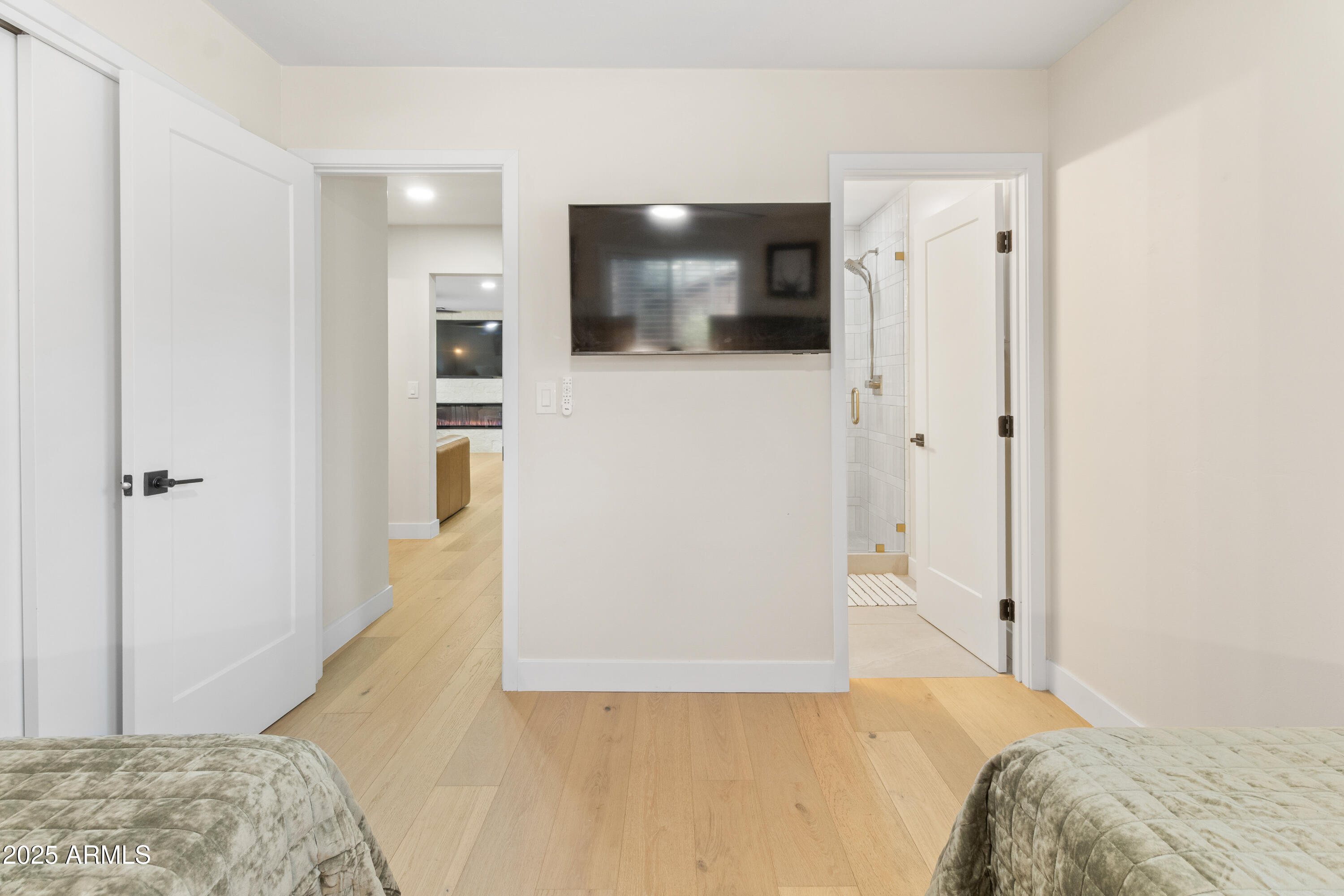 7451 Buck Springs Road Pinetop, AZ 85935 - Photo 21 of 35 a view of a bedroom with wooden floor and hallway