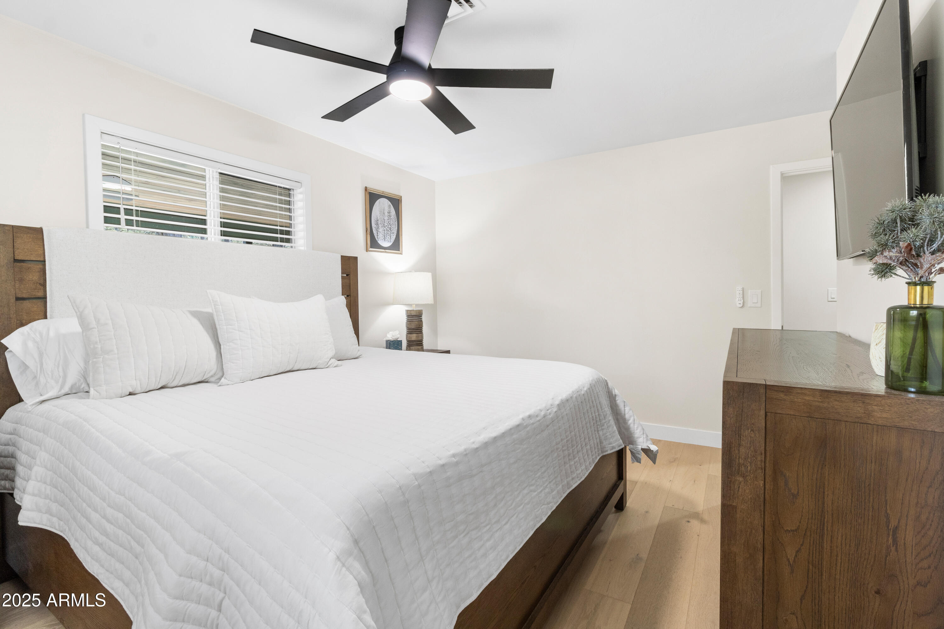 7451 Buck Springs Road Pinetop, AZ 85935 - Photo 23 of 35 a bedroom with a large bed and a flat tv screen on dresser