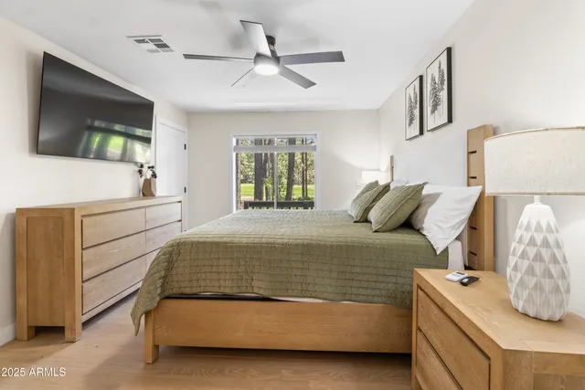 a bedroom with a bed and a flat screen tv