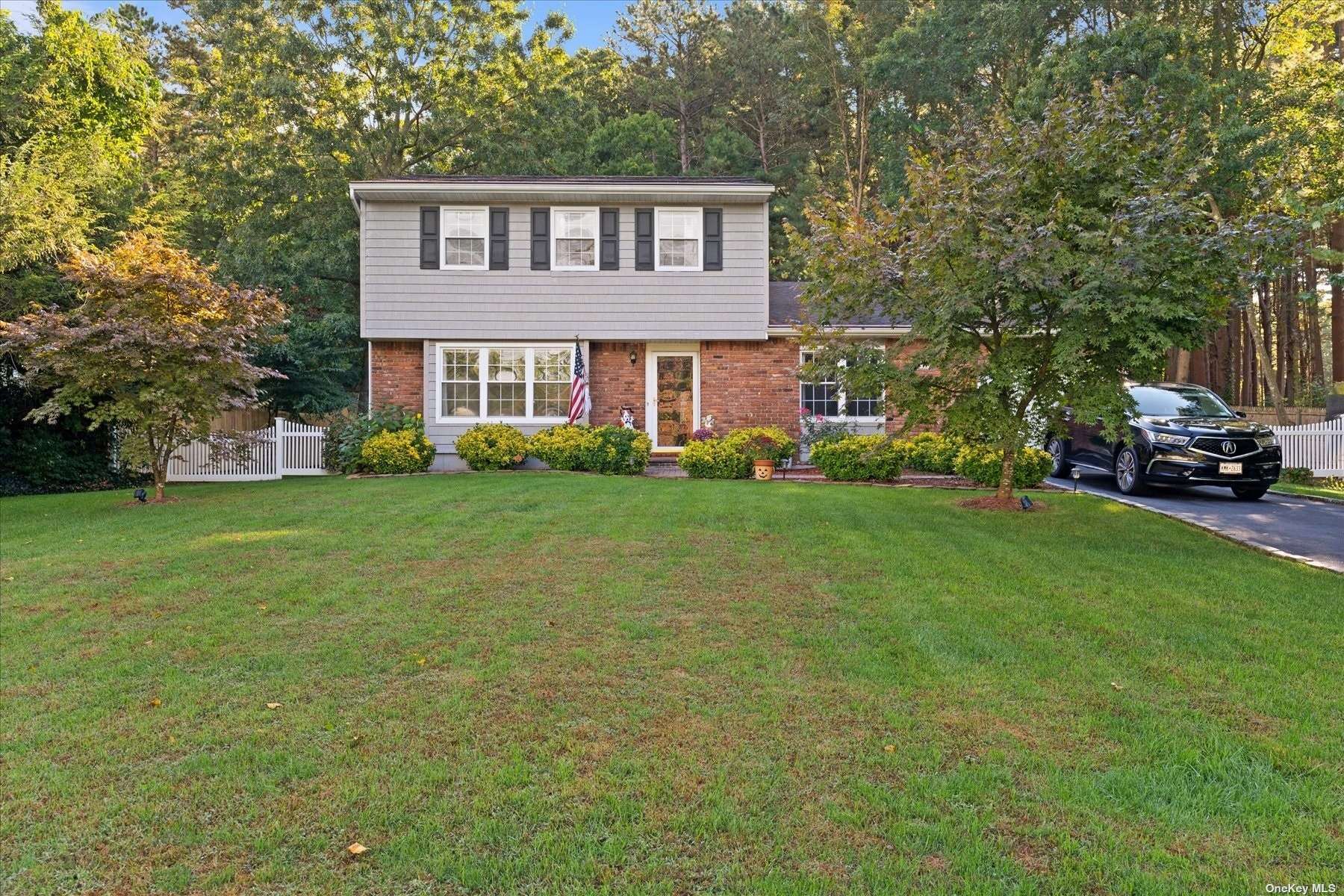 179 Wading River Hollow Road Ridge, NY 11961 - Photo 1 of 1 a front view of a house with a garden