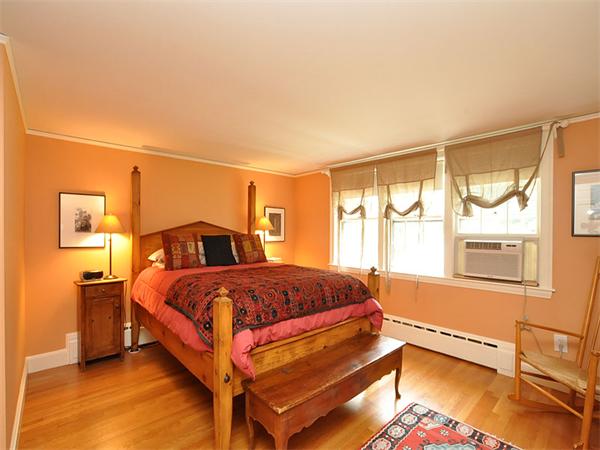 207 Concord Road Lincoln, MA 01773 - Photo 20 of 29 a bedroom with a bed and wooden floor