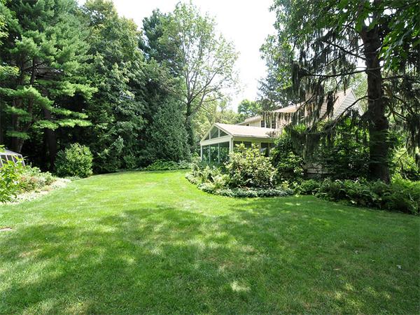 207 Concord Road Lincoln, MA 01773 - Photo 27 of 29 a view of a garden with a bench