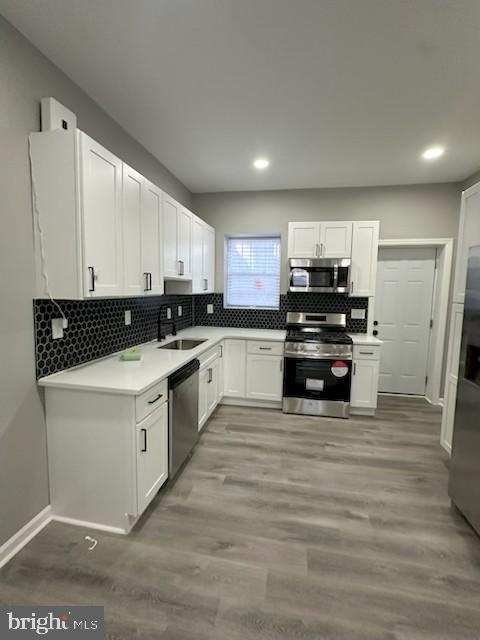 2225 West Baltimore Street Baltimore, MD 21223 - Photo 2 of 5 a kitchen with granite countertop a stove a sink and a refrigerator